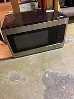 Full view of LG stainless steel countertop microwave on floor