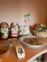 Group shot of two figurines, floral basket bowl, plate, scoop, small bowl