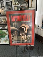 Full view of framed ARTROPOLIS poster on stand