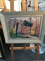 Front view of framed painting on easel