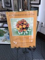 Full view of framed poster on easel