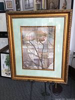 Front view of framed abstract print on easel