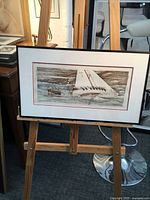 Full view of framed watercolor on easel