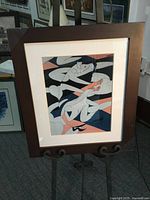 Full view of framed lithograph on easel