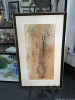 Full view of framed artwork on easel