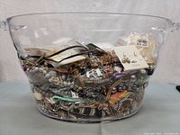 Overall view of clear bin filled with costume jewelry