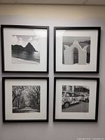 All four framed photographs displayed on wall