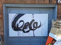 Full view of painting leaning against garage door