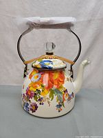 Front view of floral enamel tea kettle with lid and handle