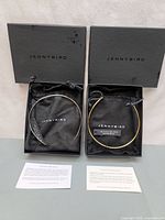 Both necklaces in boxes with pouches and cards