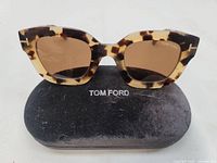 Front view of Tom Ford Pia tortoiseshell sunglasses on case
