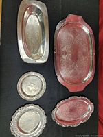 All five silver-plated platters and trays displayed
