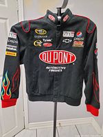 Front view of black DuPont NASCAR racing jacket on stand