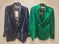 Front view of both blazers hanging side by side