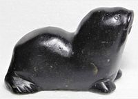 Left profile of black stone walrus carving