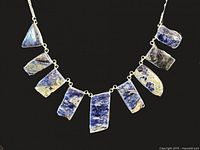 Full view of necklace showing eight sodalite stones on chain