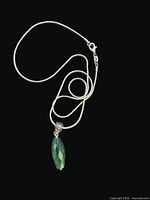 Full view of emerald pendant on sterling snake chain