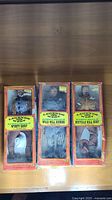 Three boxed Legends of the West figures upright