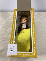 Doll in open original box with certificate visible