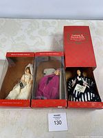 All three Peggy Nisbet dolls in their red display boxes