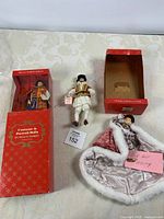 Three Peggy Nisbet dolls and two boxes overview