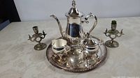 Complete tea service on tray with pair of candlesticks