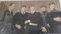 Front view of color photograph showing Ed Sullivan and the Beatles