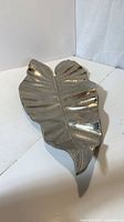 Top view of brushed silver metal leaf plate