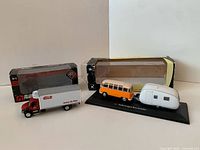Overall lot showing Erb truck, VW Bus with trailer, and both original boxes