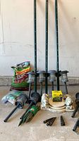 Lot overview showing stakes, fertilizers, solar lights, planter base, plastic stakes, Jiffy refill