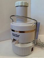Assembled juicer front view showing brand label and spout