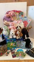 Overall lot showing plush, outfits in packaging, figurines, card album, Rubbermaid chest