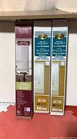 Three sealed boxes of window blinds/shade standing together