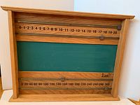 front view of wooden scoreboard showing chalkboard and scoring rails