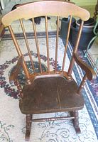 Front angled view showing full chair, spindles, arms, seat and rockers