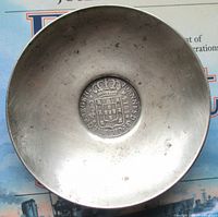Top view of silver dish showing inset coin
