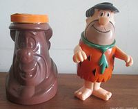 Front view of both items: vinyl figure and Grenache jar