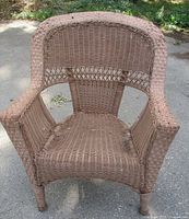 Front view of brown resin wicker armchair