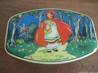 Lid showing Little Red Riding Hood artwork and Riley's Toffee branding