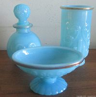 Front view of all three turquoise milk glass vanity pieces