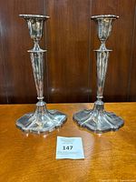 Full view of both candlesticks standing on tabletop