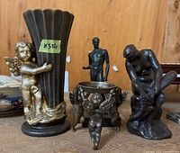 Group shot showing all four bronze-tone sculptures