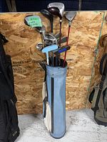Full view of blue golf bag with clubs inside