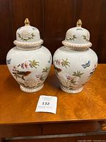 Front view of both matching ginger jars with lids on