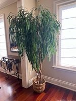 Full view of artificial tree and basket planter