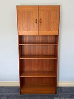 Front view of closed teak bookcase
