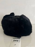 Hat folded with ear flaps up showing exterior fur