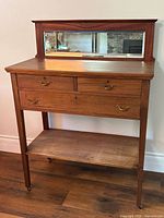 Full view of sideboard with mirror backsplash, drawers, lower shelf