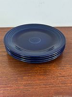 Stack of four dark cobalt blue Fiesta plates side view