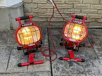 Both Husky halogen work lights powered on, showing stands, cages, cords